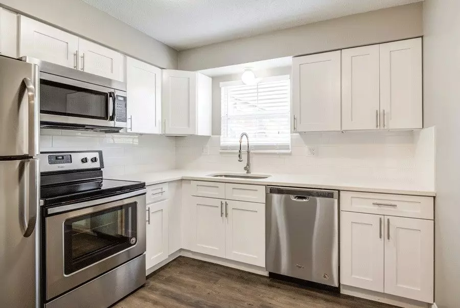 Clean, modern kitchen with stainless steel appliances in Corinth Communities, Prairie Village, Kansas.